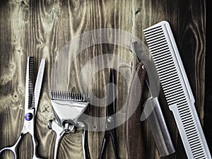 Old rusty barber shop tools on wood background