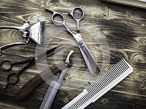 Old rusty barber shop tools on wood background