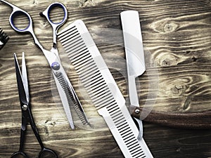 Old rusty barber shop tools on wood background