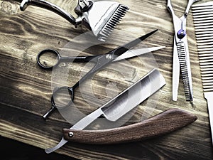 Old rusty barber shop tools on wood background