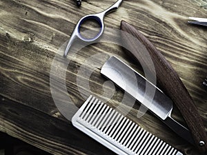 Old rusty barber shop tools on wood background