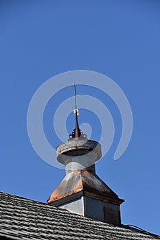 Old rusty barn cupola with a lightning rod