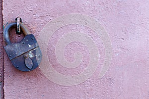 An old rusty barn lock on an iron door
