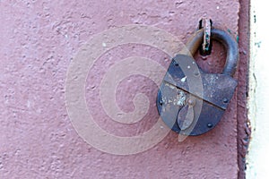An old rusty barn lock on an iron door