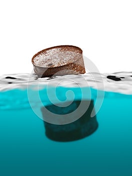 Old rusty barrel floating on the waves