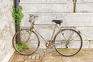 Old rusty bicycle against the wall