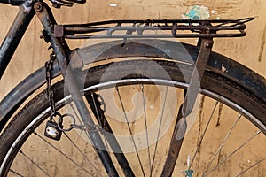 Old rusty bicycle with chain and lock on the wheel