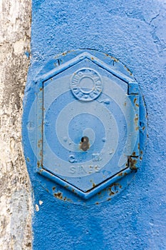 Old rusty blue painted iron lid of a valve box of the SERVICO DE AGUA photo