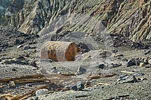 Old rusty boiler scrap metal on rocky terrain
