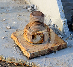 An Old Rusty Bolt and Nut in a Metal Plate