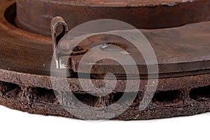 Old rusty brake disc and worn block. Used spare parts for passenger cars