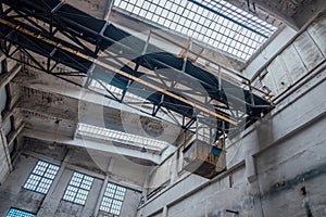 Old rusty bridge crane in abandoned factory