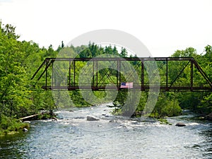 Old rusty bridge with USA flag