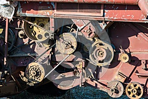 Old, rusty, broken combine harvester on the field