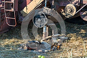 Old, rusty, broken combine harvester on the field