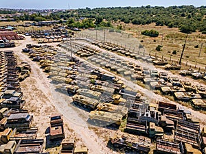 Old rusty broken Russian military vehicles in industrial area, aerial view