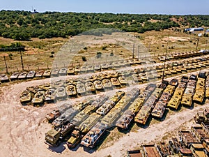 Old rusty broken Russian military vehicles in industrial area, aerial view