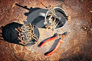 Old rusty broken tools, nails and pliers on a background of rust