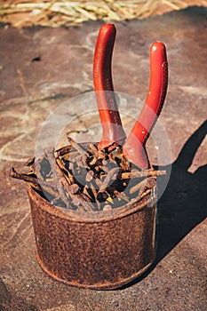 Old rusty broken tools, nails and pliers on a background of rust