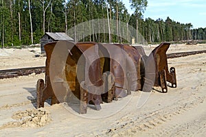 Old rusty buckets of giant mining excavators