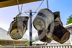 Old rusty buckets hanging from pole