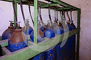 Old rusty bundle of blue gas cylinders