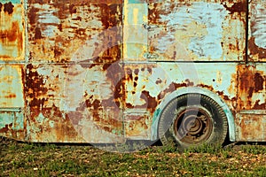 Old rusty bus on green grass