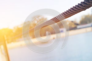 Old rusty cable and anchorage on the sea pier closeup