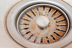 Old rusty calcified drain hole in the kitchen sink with limescale and scurf scum photo