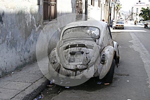 Old rusty car in the back alley in Havana, Cuba