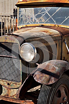 A Really Old Rusty Car with Broken Window