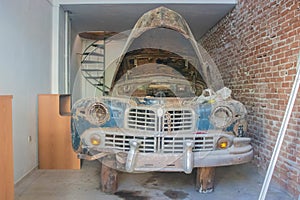 Old rusty car repair in a garage