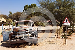 Old rusty car and road sign in Solitaire, Namibia