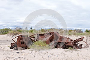 Old rusty car on a sand