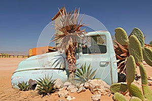 Old and rusty car wreck at the last gas station before the Namib desert. Solitaire, Namibia