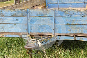 An old rusty cargo trailer stands still.