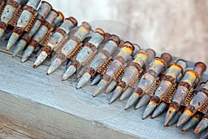 Old rusty cartridges in a machine-gun belt. war in Ukraine. military ammunition