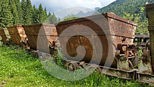 Old rusty carts for transporting materials from the mine. Schilpario, Bergamo, Italy