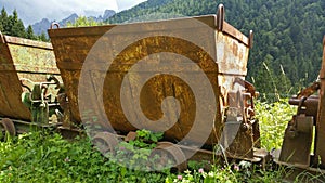 Old rusty carts for transporting materials from the mine. Schilpario, Bergamo, Italy