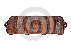 Old, rusty, cast-iron corn stick pan isolated on white