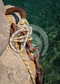 Old rusty chain and ropes to moor a boat