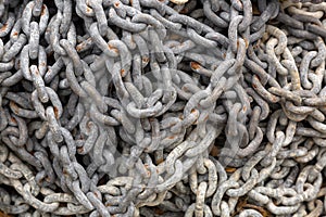 Old rusty chains used in fishing industry full of aged red rust