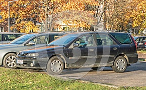 Old rusty cheap car Renault Laguna hatchback first model parked