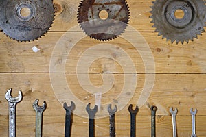 Old rusty circular saw blades and wrenches