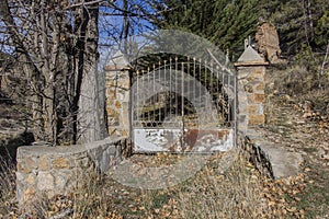 Old rusty closed iron gate at the entrance to the garden