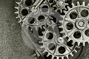 Old rusty cogs and wheels on rusty background
