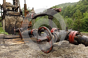 Old rusty crane for supplying oil