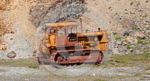 Old rusty crawler tractor with shovel