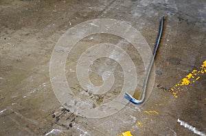 The old rusty crowbar on the floor,work tool of builder