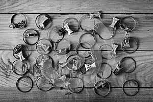 Old rusty curtain clips are placed on a wooden surface, top view, the effect of antiquity